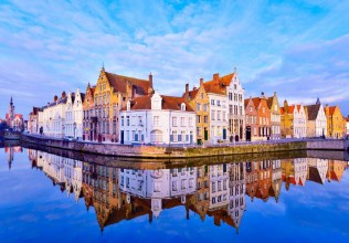 Picture of Cityscape view of Bruges and traditional houses reflected in water at sunrise in Belgium