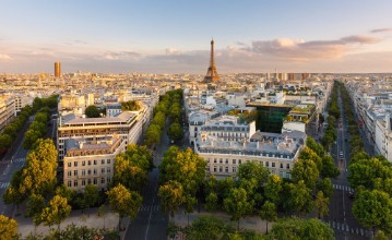 Picture of Paris from above showcasing rooftops the Eiffel Tower tree-lined avenues with haussmannian buildings lit by the setting sun Avenue Kleber Avenue dIena and Avenue Marceau 16th arrondissement