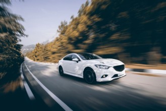 Picture of White car speed driving on asphalt road at daytime