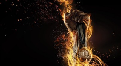 Bild på Sport Mans hand holding up trophy medal Winner in a competition Fire and energy