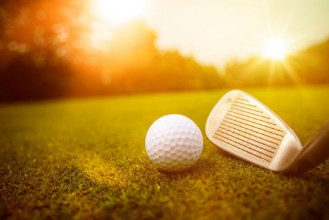 Image de Golfplatz im Abendrot mit Loch und Golfball und Fahne