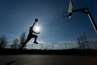 Picture of Basketball player silhouette taking off to slam dunk