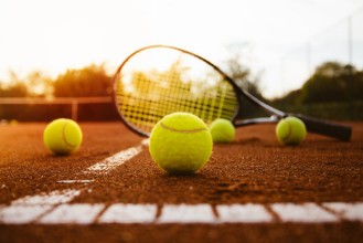 Picture of Tennis balls with racket on clay court