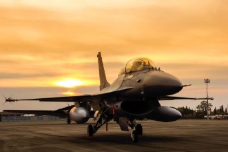 Picture of F16 falcon fighter jet on sunset  background 
